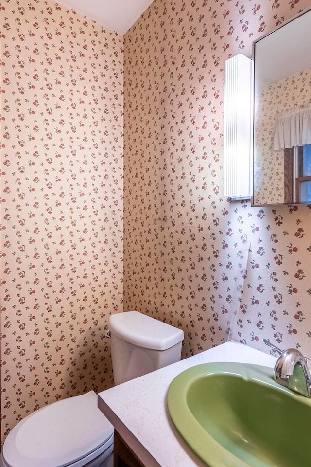 1311 Hickory St, Onalaska, WI 54650 - half bath featuring vanity and wallpapered walls