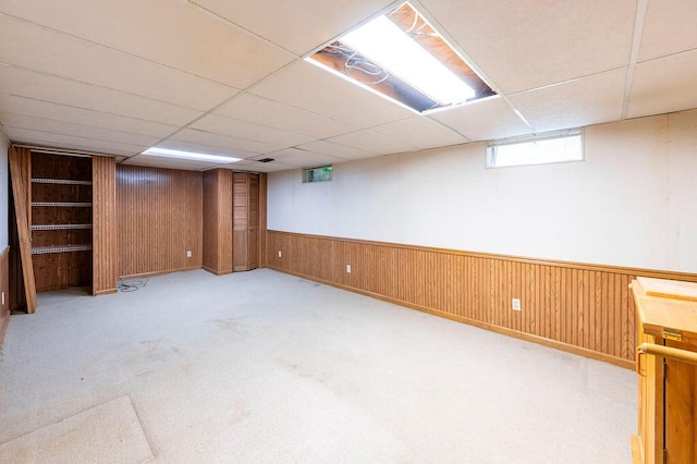 1311 Hickory St, Onalaska, WI 54650 - below grade area with a drop ceiling, wood walls, and carpet