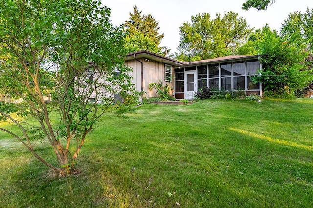 1311 Hickory St, Onalaska, WI 54650 - rear view of property featuring a sunroom and a yard