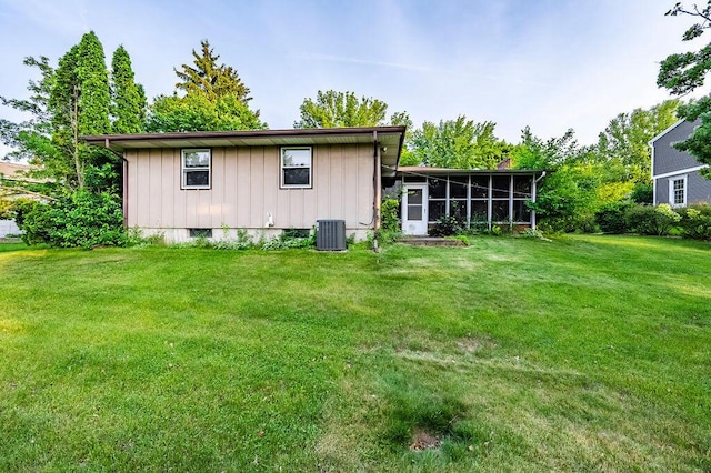 1311 Hickory St, Onalaska, WI 54650 - back of property with board and batten siding, a sunroom, and a yard