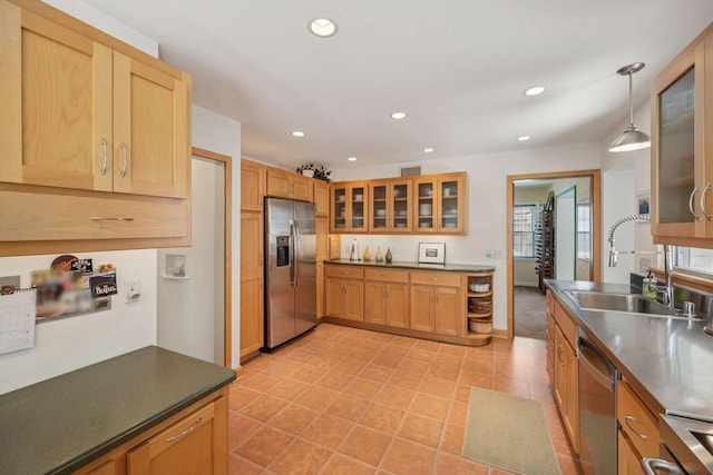 5961 N Lake Dr, Whitefish Bay, WI 53217 - kitchen featuring appliances with stainless steel finishes, light tile patterned floors, glass insert cabinets, recessed lighting, and hanging light fixtures