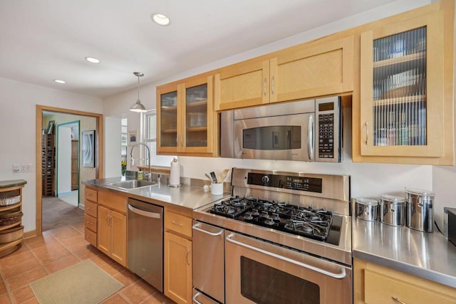 5961 N Lake Dr, Whitefish Bay, WI 53217 - kitchen with stainless steel counters, stainless steel appliances, light brown cabinets, recessed lighting, and hanging light fixtures