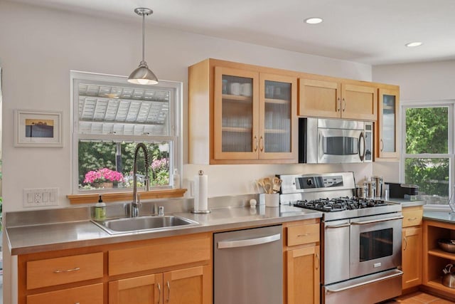 5961 N Lake Dr, Whitefish Bay, WI 53217 - kitchen with stainless steel appliances, stainless steel counters, hanging light fixtures, glass insert cabinets, and recessed lighting