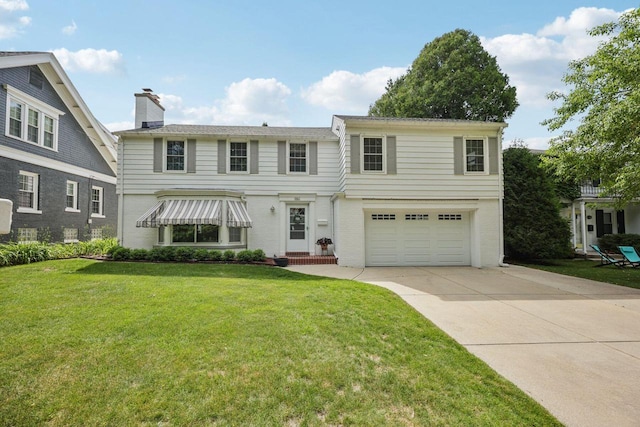 5961 N Lake Dr, Whitefish Bay, WI 53217 - view of front of home with an attached garage, driveway, a front lawn, brick siding, and a chimney