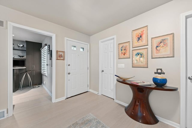 9125 N Briarwood Ct, Bayside, WI 53217 - entryway with wood finished floors and baseboards