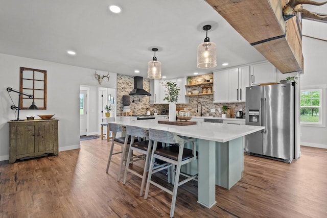 N6965 Thede Rd, Black Creek, WI 54106 - kitchen with stainless steel fridge, wall chimney range hood, tasteful backsplash, light countertops, and open shelves