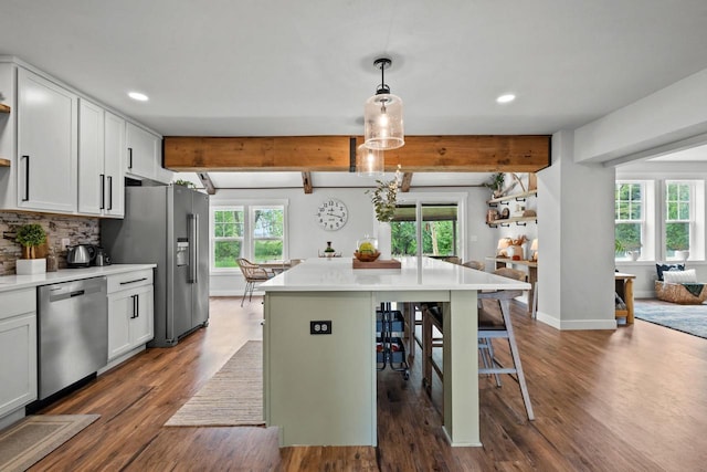 N6965 Thede Rd, Black Creek, WI 54106 - kitchen with appliances with stainless steel finishes, a kitchen breakfast bar, recessed lighting, dark wood-type flooring, and beamed ceiling