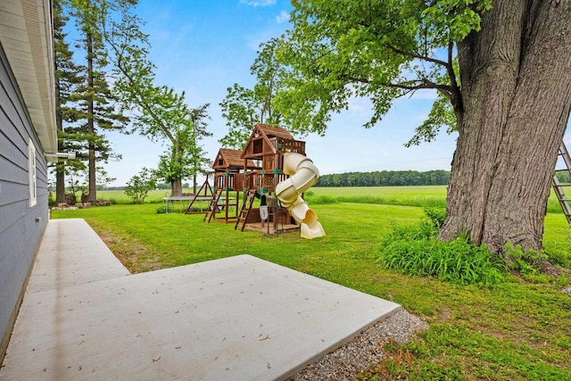 N6965 Thede Rd, Black Creek, WI 54106 - view of green lawn featuring a playground and a patio area