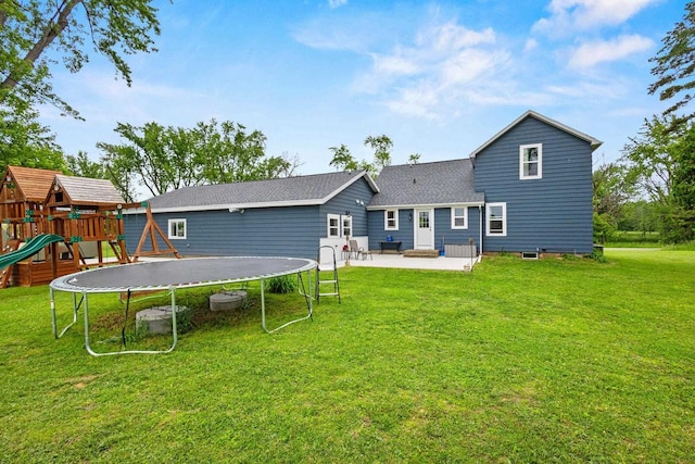 N6965 Thede Rd, Black Creek, WI 54106 - rear view of house with a trampoline, a patio area, a yard, and roof with shingles