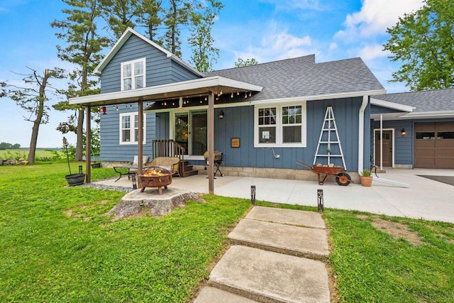 N6965 Thede Rd, Black Creek, WI 54106 - back of house with an outdoor fire pit, a lawn, board and batten siding, and a shingled roof