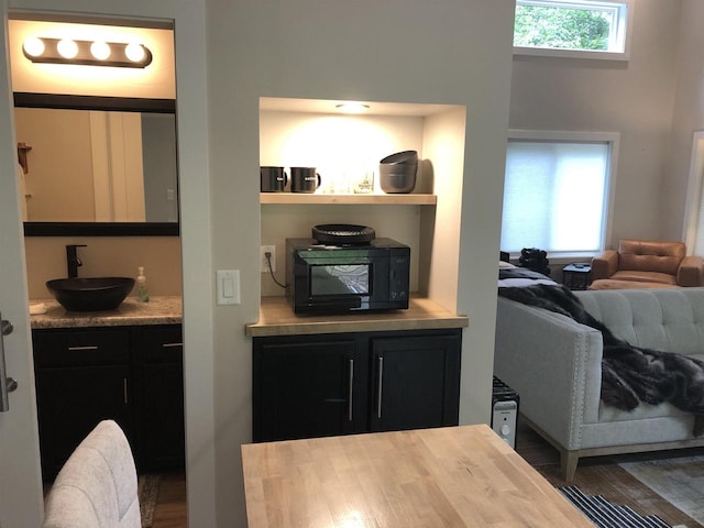 N4857 Oak Valley Ln, Elroy, WI 53929 - kitchen featuring black microwave, dark cabinetry, open shelves, and light countertops