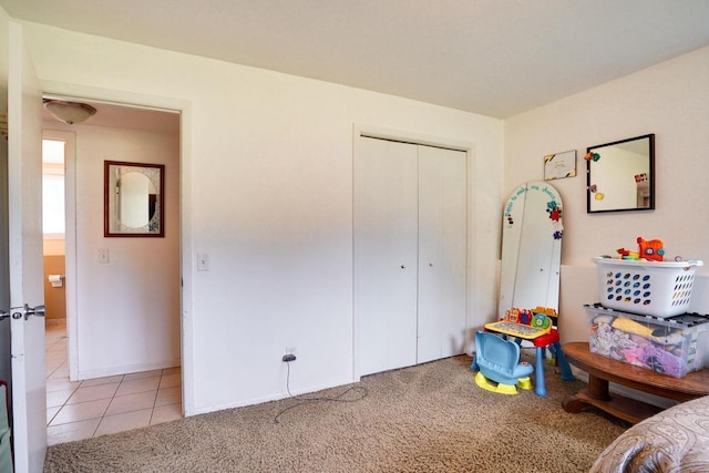 2743 Bluebird Ln, Cottage Grove, WI 53527 - bedroom featuring a closet, light tile patterned floors, and light carpet