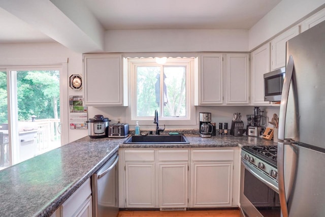 2743 Bluebird Ln, Cottage Grove, WI 53527 - kitchen with stainless steel appliances, healthy amount of natural light, and white cabinets