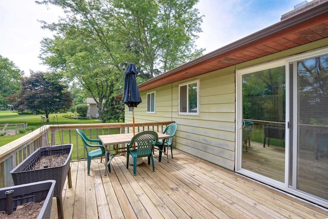 2743 Bluebird Ln, Cottage Grove, WI 53527 - wooden terrace featuring outdoor dining space and a lawn