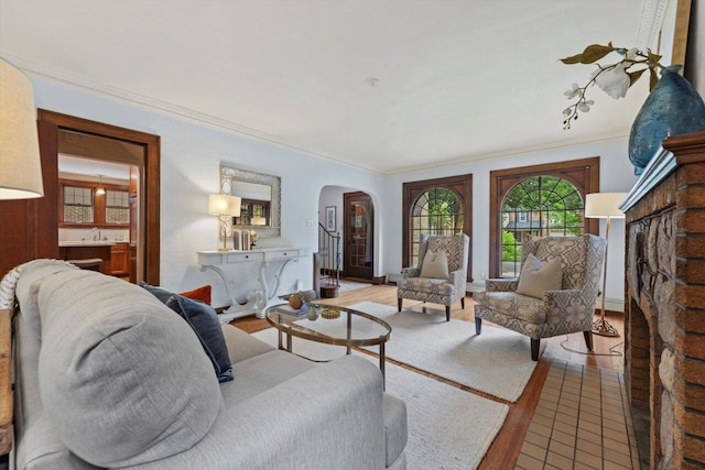 4765 N Woodburn St, Whitefish Bay, WI 53211 - living room featuring arched walkways, ornamental molding, and wood finished floors