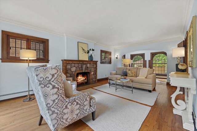 4765 N Woodburn St, Whitefish Bay, WI 53211 - living room featuring ornamental molding, a stone fireplace, wood finished floors, arched walkways, and a baseboard heating unit
