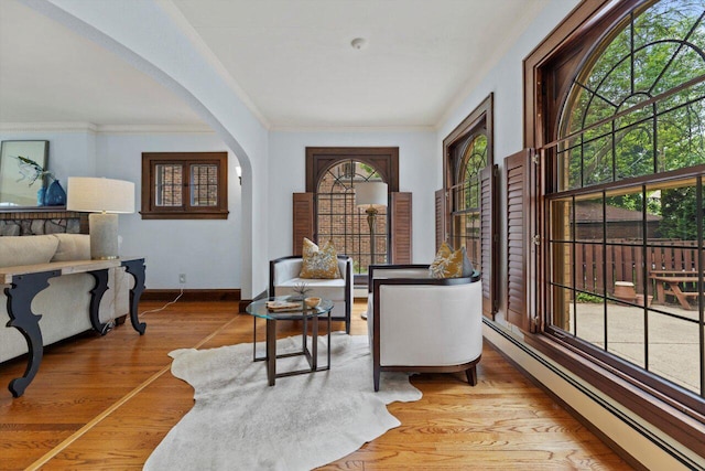 4765 N Woodburn St, Whitefish Bay, WI 53211 - sitting room with a baseboard radiator, arched walkways, ornamental molding, and wood finished floors