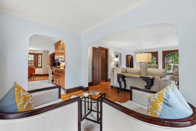 4765 N Woodburn St, Whitefish Bay, WI 53211 - living area with arched walkways, plenty of natural light, light wood-style floors, and crown molding