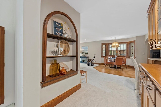 4765 N Woodburn St, Whitefish Bay, WI 53211 - hall with light carpet and a chandelier