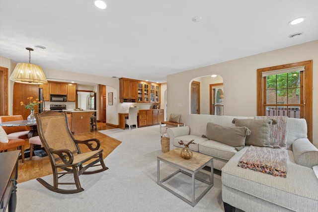 4765 N Woodburn St, Whitefish Bay, WI 53211 - living room with arched walkways, recessed lighting, and light carpet