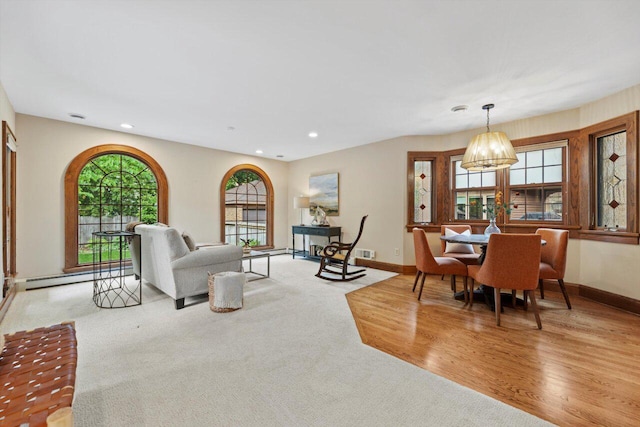 4765 N Woodburn St, Whitefish Bay, WI 53211 - carpeted living area with a baseboard radiator, recessed lighting, a chandelier, and wood finished floors