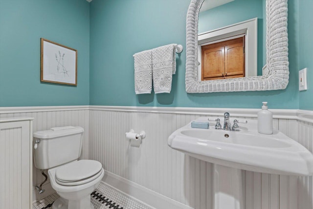 4765 N Woodburn St, Whitefish Bay, WI 53211 - bathroom with radiator, wainscoting, and tile patterned flooring