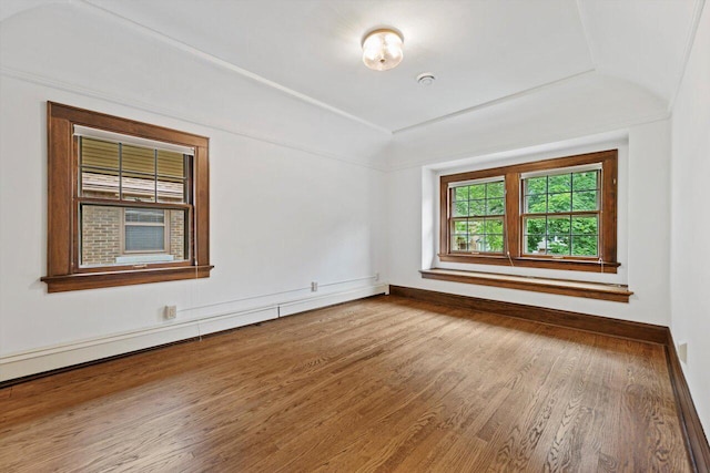 4765 N Woodburn St, Whitefish Bay, WI 53211 - empty room with wood finished floors and a baseboard heating unit
