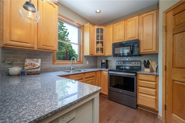 2193 County Road C, New Richmond, WI 54017 - kitchen with stainless steel range with electric stovetop, black microwave, glass insert cabinets, light wood-style floors, and stone countertops