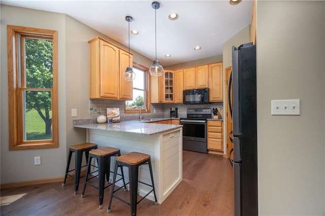 2193 County Road C, New Richmond, WI 54017 - kitchen featuring stainless steel appliances, a peninsula, healthy amount of natural light, tasteful backsplash, and recessed lighting