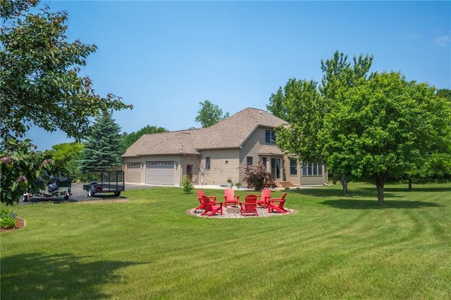 2193 County Road C, New Richmond, WI 54017 - rear view of property with a yard, an attached garage, and a fire pit