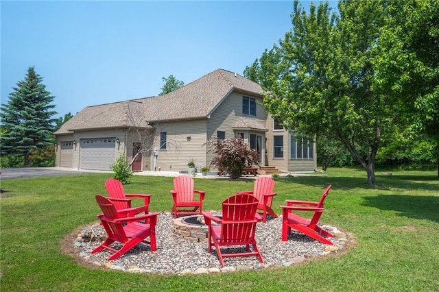 2193 County Road C, New Richmond, WI 54017 - back of house with an outdoor fire pit, an attached garage, a yard, and driveway