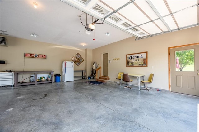2193 County Road C, New Richmond, WI 54017 - garage with freestanding refrigerator and a garage door opener
