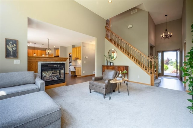 2193 County Road C, New Richmond, WI 54017 - living area with a towering ceiling, stairs, a multi sided fireplace, recessed lighting, and dark colored carpet