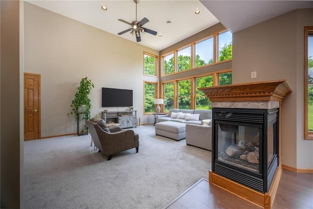 2193 County Road C, New Richmond, WI 54017 - living room featuring a multi sided fireplace, ceiling fan, healthy amount of natural light, high vaulted ceiling, and recessed lighting