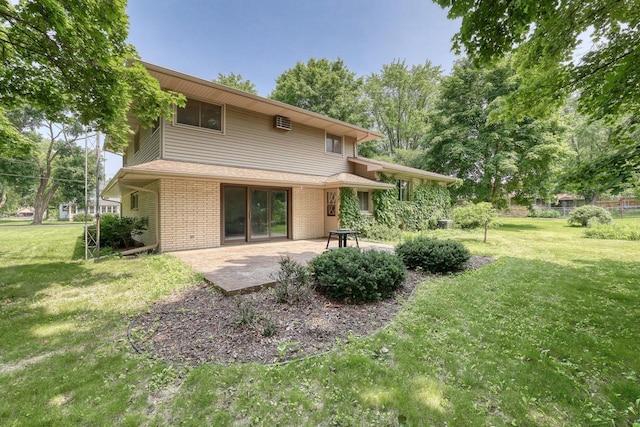 627 W Wisconsin St, Palmyra, WI 53156 - back of house with a patio area, brick siding, and a yard