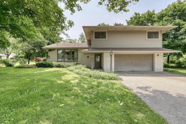 627 W Wisconsin St, Palmyra, WI 53156 - tri-level home featuring an attached garage, driveway, brick siding, and a front yard
