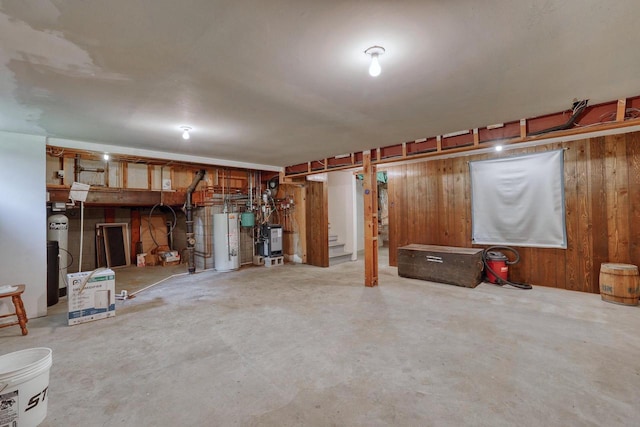 627 W Wisconsin St, Palmyra, WI 53156 - finished below grade area featuring gas water heater, wood walls, and a heating unit