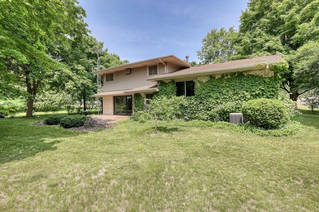 627 W Wisconsin St, Palmyra, WI 53156 - back of house featuring a yard, a patio, and brick siding