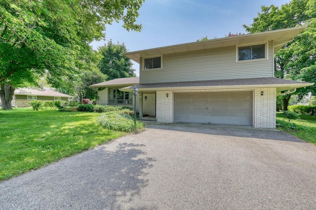 627 W Wisconsin St, Palmyra, WI 53156 - split level home featuring an attached garage, brick siding, driveway, and a front lawn
