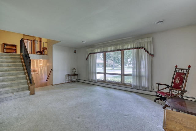 627 W Wisconsin St, Palmyra, WI 53156 - living room featuring a baseboard heating unit, carpet, and stairs