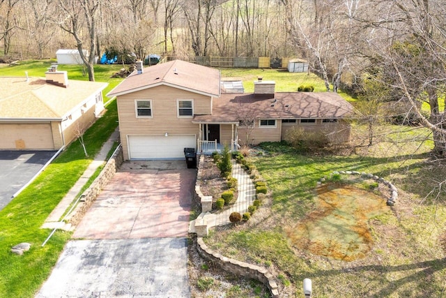 1625 W Green Tree Rd, Glendale, WI 53209 - traditional-style home featuring a garage, concrete driveway, a chimney, and a front yard
