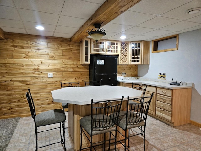 200890 Robin Rd, Marshfield, WI 54449 - kitchen with freestanding refrigerator, a paneled ceiling, a breakfast bar, light countertops, and a kitchen island