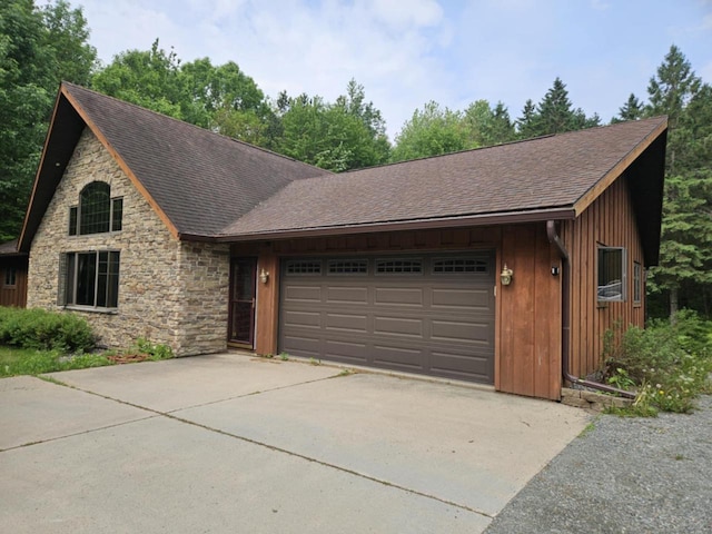 200890 Robin Rd, Marshfield, WI 54449 - view of front of home with stone siding, an attached garage, roof with shingles, and driveway