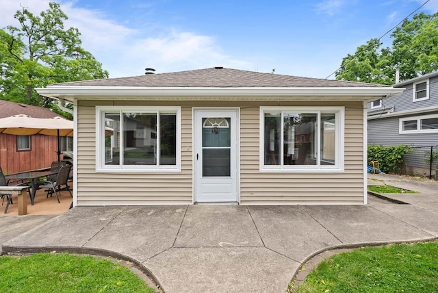 N1808 Woodland Rd, Lake Geneva, WI 53147 - rear view of house featuring a patio and a shingled roof