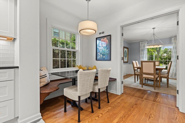 6123 N Berkeley Blvd, Whitefish Bay, WI 53217 - dining room featuring plenty of natural light, light wood-type flooring, breakfast area, and a wainscoted wall