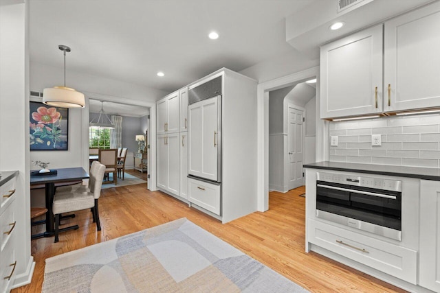 6123 N Berkeley Blvd, Whitefish Bay, WI 53217 - kitchen featuring stainless steel oven, dark countertops, backsplash, light wood-style flooring, and recessed lighting