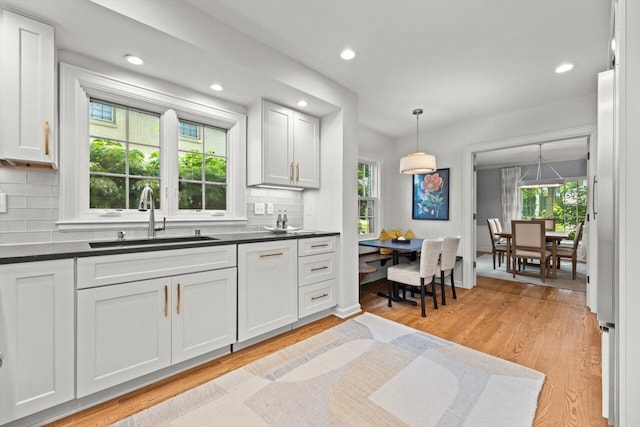 6123 N Berkeley Blvd, Whitefish Bay, WI 53217 - kitchen with backsplash, dark countertops, white cabinets, and recessed lighting
