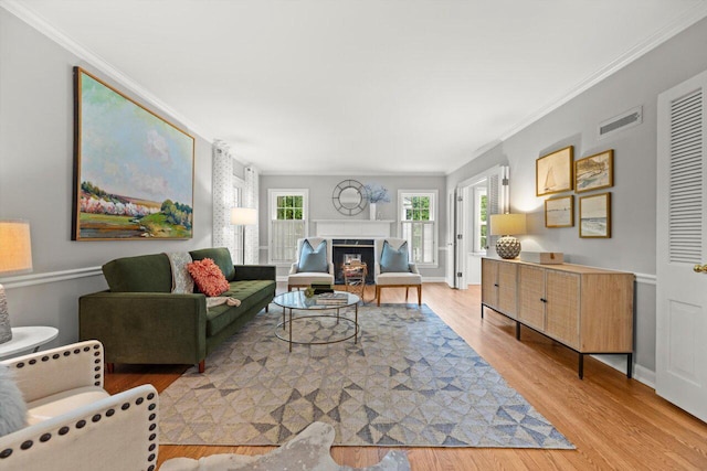 6123 N Berkeley Blvd, Whitefish Bay, WI 53217 - living area with light wood-type flooring, ornamental molding, and a fireplace