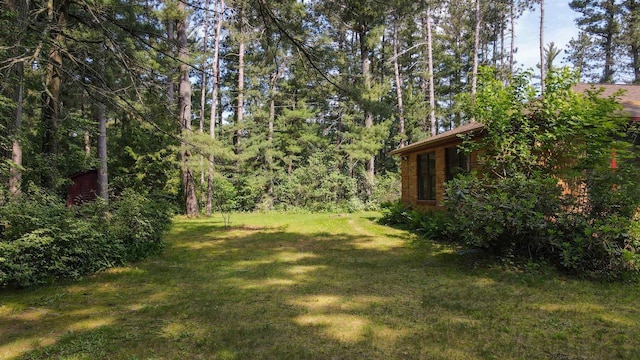 452 Woodland Dr, Wisconsin Rapids, WI 54494 - view of grassy yard featuring a forest view