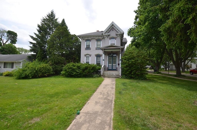 727 W Center St, Whitewater, WI 53190 - italianate-style house featuring a front lawn and a chimney